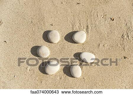 Pebbles arranged in circle on sand View Large Photo Image Stock Image - Pebbles arranged in circle on sand. Fotosearch
