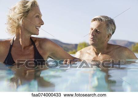 Retired couple soaking in pool View Large Photo Image Stock Image - Retired couple soaking in pool. Fotosearch