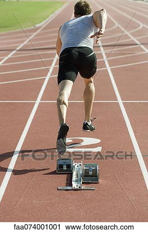 Runner at starting line, rear view View Large Photo Image Stock Image - Runner at starting line, rear view. Fotosearch