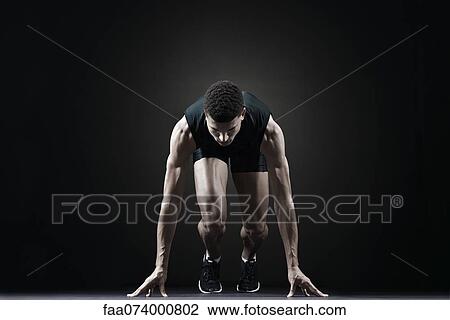 Stock Image - Runner at starting line. Fotosearch