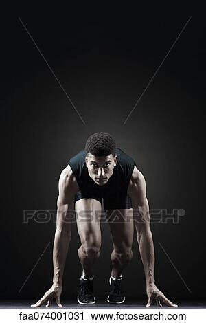 Stock Image - Runner at starting line. Fotosearch