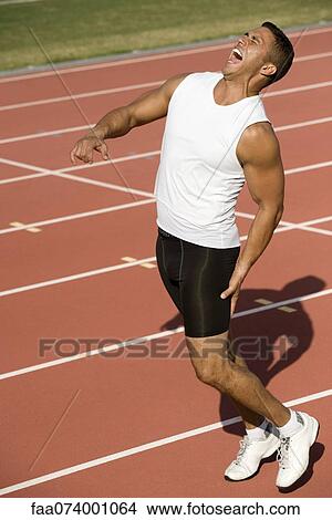 Runner on running track with painful expression View Large Photo Image Picture - Runner on running track with painful expression. Fotosearch