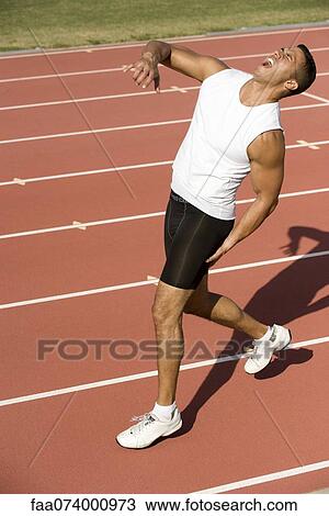 Runner on running track with painful expression View Large Photo Image Stock Image - Runner on running track with painful expression. Fotosearch