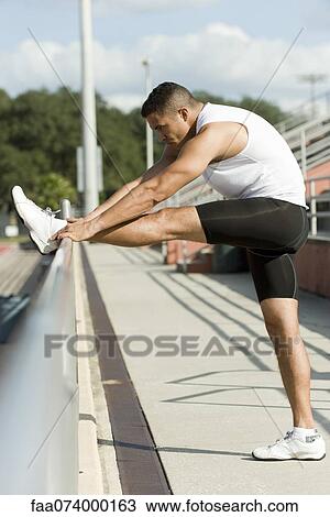 Stock Image - Runner stretching. Fotosearch