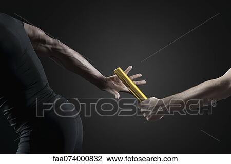 Runners passing baton, cropped View Large Photo Image Stock Image - Runners passing baton, cropped. Fotosearch