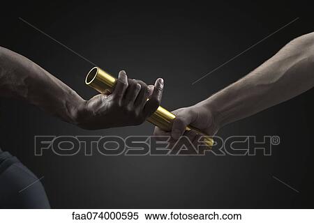 Runners passing baton, cropped View Large Photo Image Stock Photography - Runners passing baton, cropped. Fotosearch