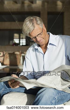 Stock Image - Senior man reading newspaper. Fotosearch
