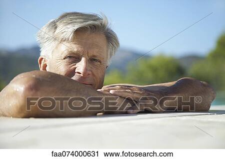 Senior man relaxing at poolside, portrait View Large Photo Image Stock Image - Senior man relaxing at poolside, portrait. Fotosearch