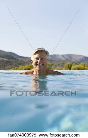 Senior man relaxing in pool, portrait View Large Photo Image Stock Photography - Senior man relaxing in pool, portrait. Fotosearch