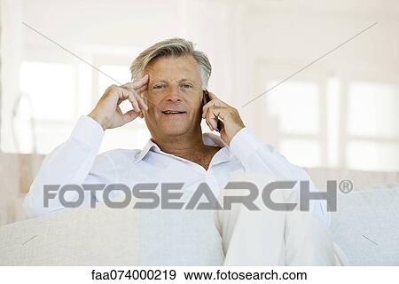 Stock Photo - Senior man talking on cell phone. Fotosearch