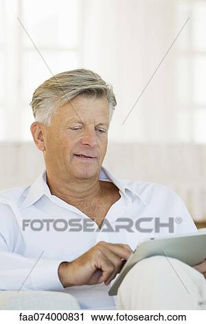 Senior man using digital tablet View Large Photo Image Stock Image - Senior man using digital tablet. Fotosearch