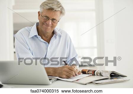Stock Photography - Senior man working at home. Fotosearch