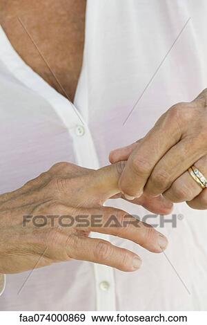 Senior woman rubbing knuckles, cropped View Large Photo Image Stock Photo - Senior woman rubbing knuckles, cropped. Fotosearch