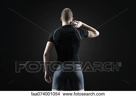 Shot putter holding shot, rear view View Large Photo Image Picture - Shot putter holding shot, rear view. Fotosearch