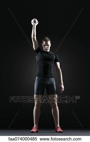 Stock Photography - Shot putter holding shot. Fotosearch