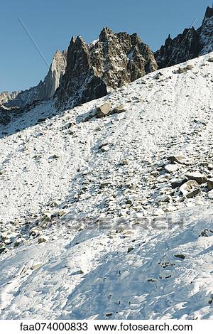 Snowy mountain slope and mountain peak View Large Photo Image Stock Image - Snowy mountain slope and mountain peak. Fotosearch