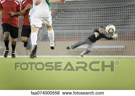 Soccer player shooting ball at goal, cropped View Large Photo Image Stock Photo - Soccer player shooting ball at goal, cropped. Fotosearch