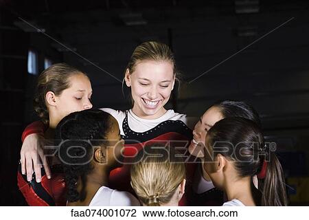 Team of female gymnasts embracing View Large Photo Image Stock Image - Team of female gymnasts embracing. Fotosearch