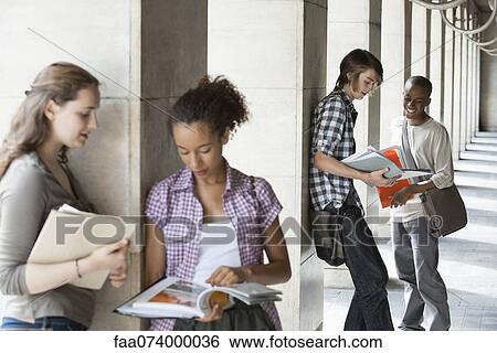 University students discussing homework, focus on men in background View Large Photo Image Stock Photograph - University students discussing homework, focus on men in background. Fotosearch