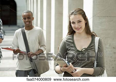 Stock Photo - University students on campus, focus on woman in foreground. Fotosearch