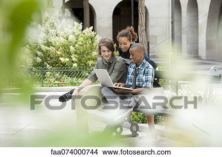 Picture - University students using laptop computer on campus. Fotosearch