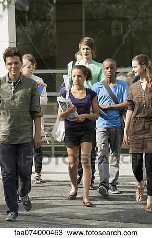 University students walking on campus View Large Photo Image Stock Image - University students walking on campus. Fotosearch
