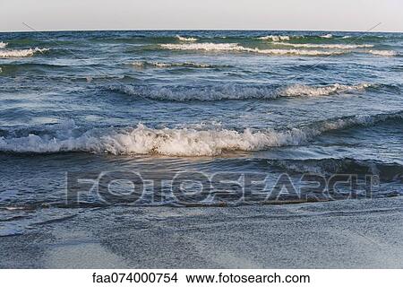 Wave breaking on beach View Large Photo Image Picture - Wave breaking on beach. Fotosearch