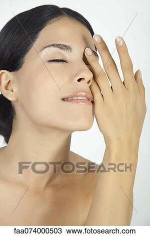 Woman covering one eye with hand, portrait View Large Photo Image Stock Image - Woman covering one eye with hand, portrait. Fotosearch