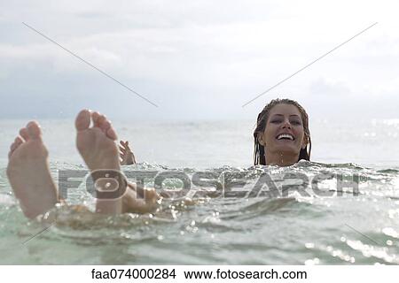 Woman floating in sea View Large Photo Image Picture - Woman floating in sea. Fotosearch