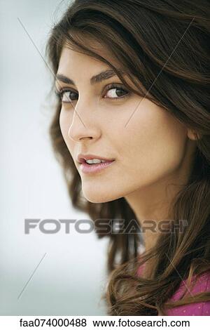 Woman glancing sideways at camera, portrait View Large Photo Image Stock Photo - Woman glancing sideways at camera, portrait. Fotosearch