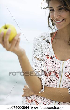 Woman holding apple View Large Photo Image Picture - Woman holding apple. Fotosearch