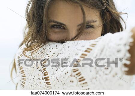 Woman holding arm in front of face, portrait View Large Photo Image Picture - Woman holding arm in front of face, portrait. Fotosearch