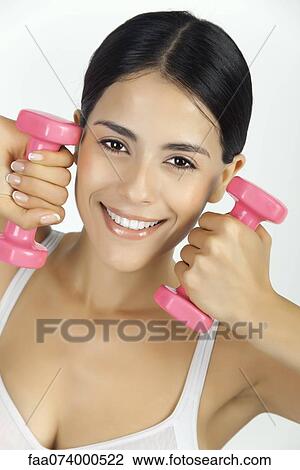 Woman lifting dumbbells, portrait View Large Photo Image Stock Image - Woman lifting dumbbells, portrait. Fotosearch