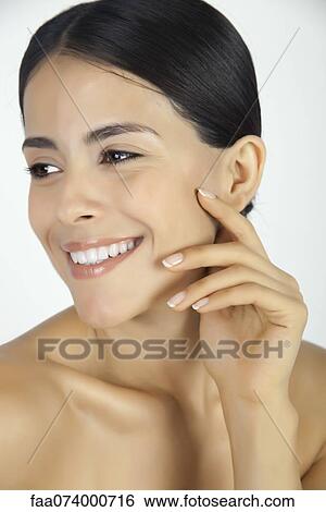 Stock Photograph - Woman looking away, smiling, portrait. Fotosearch