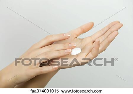 Stock Photography - Woman moisturizing hands. Fotosearch