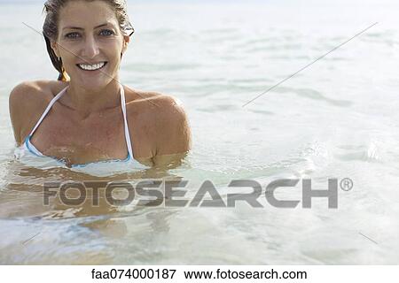 Stock Photo - Woman swimming, portrait. Fotosearch