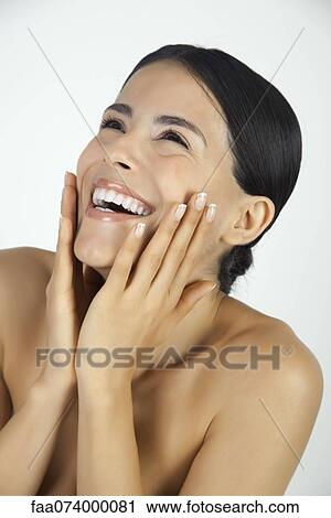 Woman touching face and laughing, portrait View Large Photo Image Stock Image - Woman touching face and laughing, portrait. Fotosearch