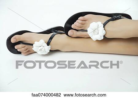 Woman wearing sandals decorated with flowers, cropped View Large Photo Image Stock Image - Woman wearing sandals decorated with flowers, cropped. Fotosearch