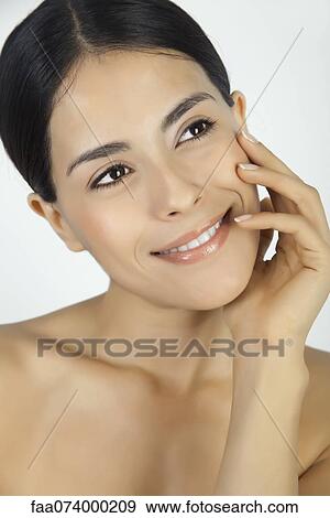 Stock Photo - Woman with hand under chin, portrait. Fotosearch