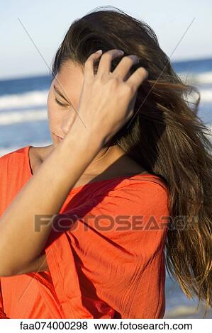 Stock Photo - Woman's hair blowing in wind. Fotosearch