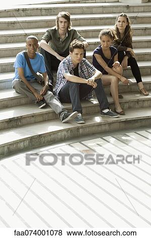 Young adults sitting on steps View Large Photo Image Stock Photo - Young adults sitting on steps. Fotosearch