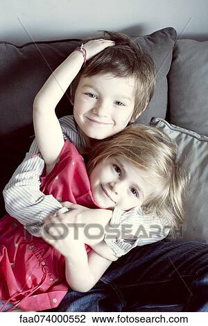 Young brother and sister embracing, portrait View Large Photo Image Stock Image - Young brother and sister embracing, portrait. Fotosearch