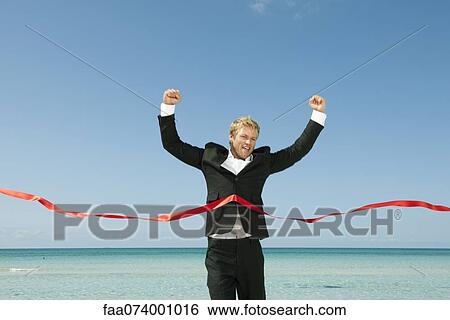 Young businessman crossing finishing line View Large Photo Image Stock Photograph - Young businessman crossing finishing line. Fotosearch
