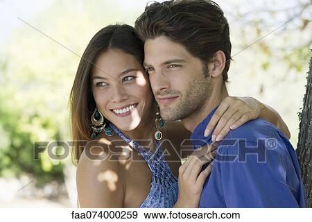 Young couple embracing, portrait View Large Photo Image Stock Photo - Young couple embracing, portrait. Fotosearch