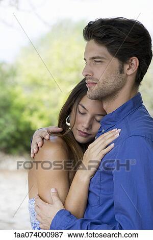 Young couple embracing, portrait View Large Photo Image Stock Photo - Young couple embracing, portrait. Fotosearch