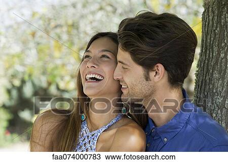 Young couple laughing, portrait View Large Photo Image Stock Image - Young couple laughing, portrait. Fotosearch