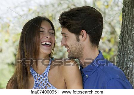 Young couple laughing, portrait View Large Photo Image Stock Image - Young couple laughing, portrait. Fotosearch