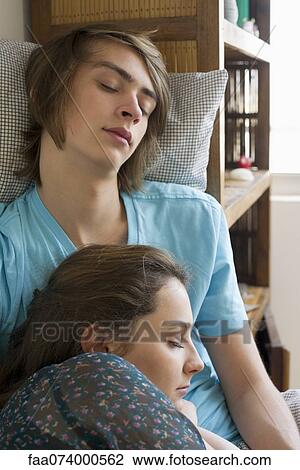 Young couple napping together View Large Photo Image Stock Image - Young couple napping together. Fotosearch