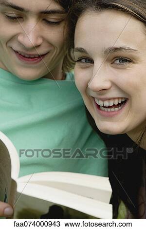 Young couple reading book together, portrait View Large Photo Image Stock Image - Young couple reading book together, portrait. Fotosearch