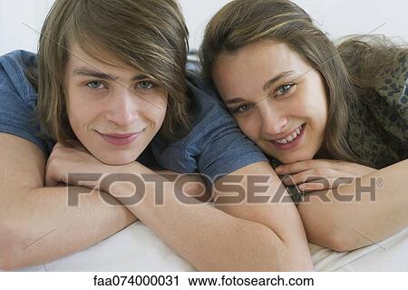 Stock Image - Young couple relaxing together, portrait. Fotosearch
